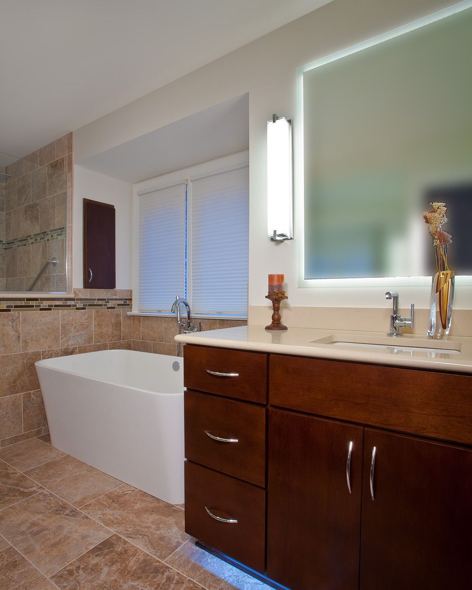 Remodeled bathroom with a tiled walk-in shower and glass screen