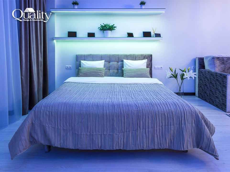 Bedroom lit with layered warm lighting at dusk