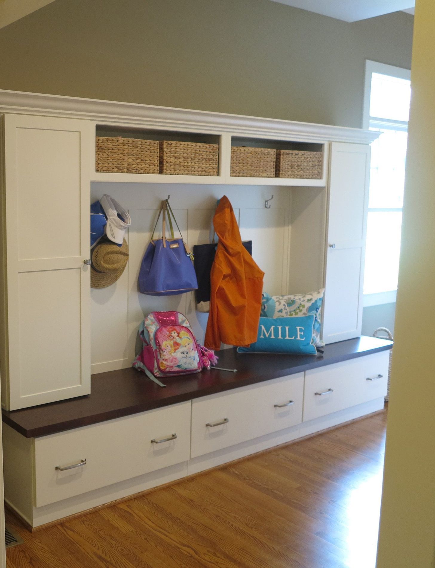 New mudroom with bench seating, hooks and built-in cubby storage