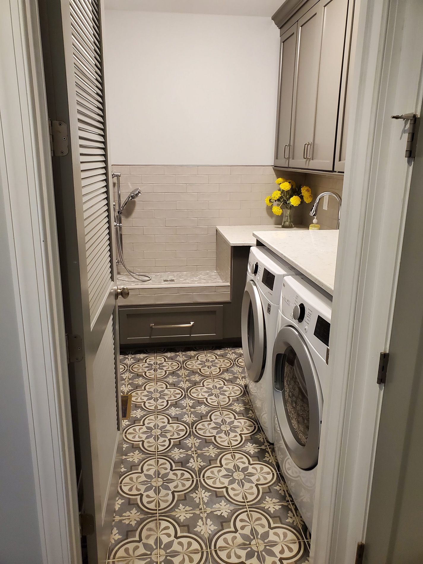 Dog washing station built into a laundry room with a tiled surround